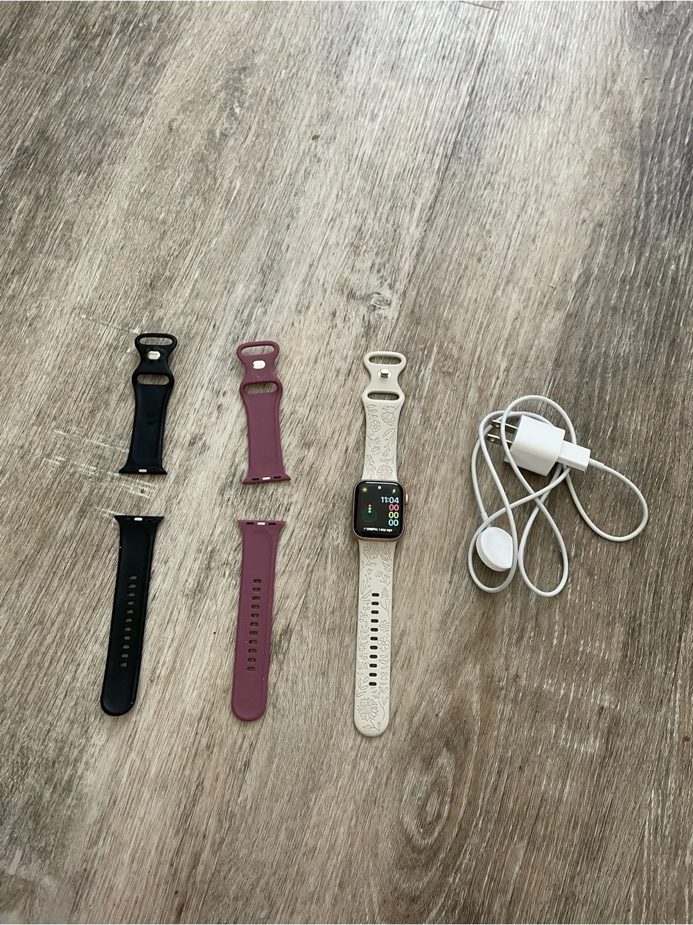 Apple Smartwatch with White, Black, and Mauve Bands